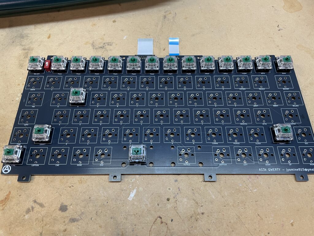 Keyboard PCB partially populated with key switches.