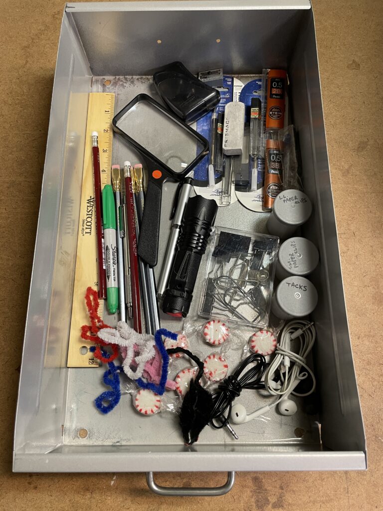 Disorganized office drawer.